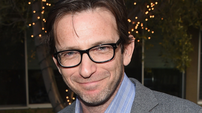 Dan Futterman posing in glasses