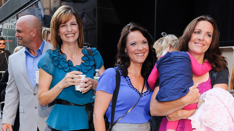 Joe Darger with his three wives walking