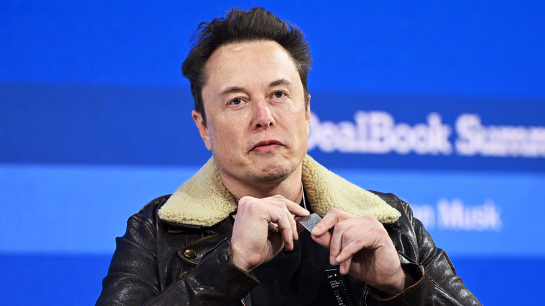 Elon Musk speaking on a panel at an event