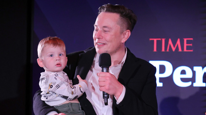 Elon Musk posing on-stage with his son