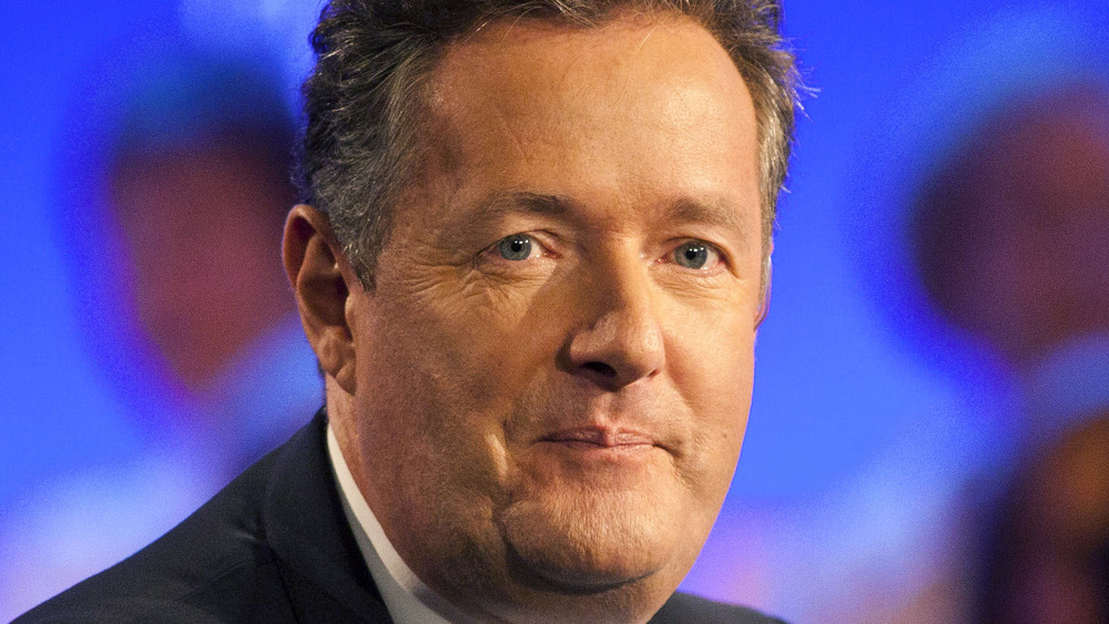 Piers Morgan posing for photos