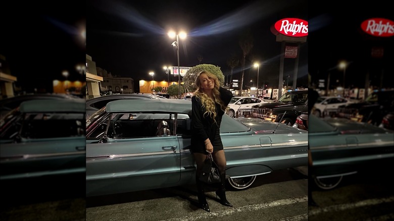 Mariah Carey posing on a parking lot