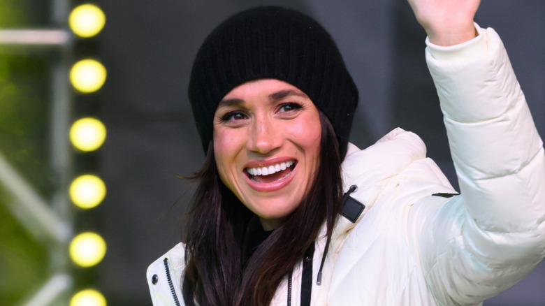 Meghan Markle smiling and waving