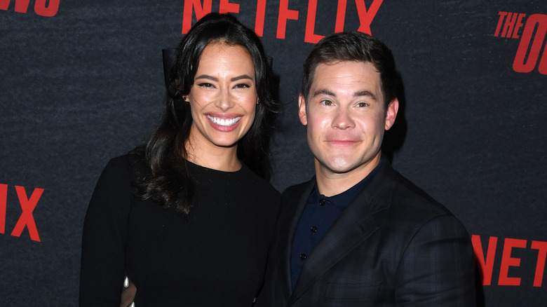 Chloe Bridges and Adam Devine wearing black
