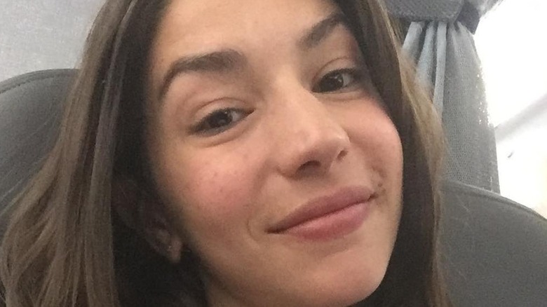 Jamie Gray Hyder displays a soft smile while her head is tilted to the side.