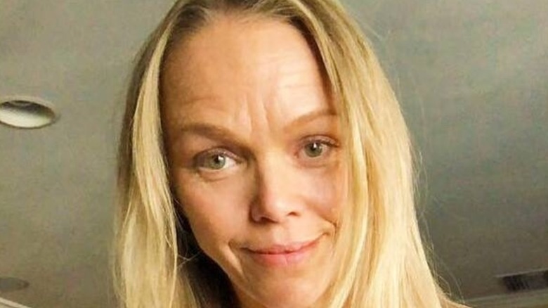 Lauren Bowles flashes a light smile while makeup-free.