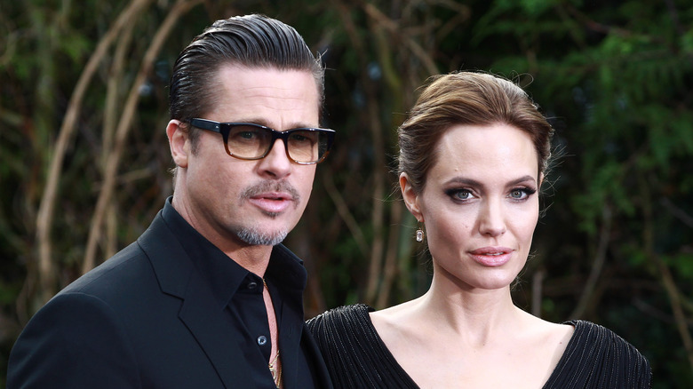 Brad Pitt and Angelina Jolie attend a 2014 Maleficent exhibition