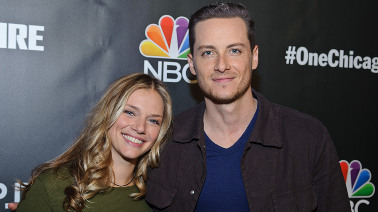 Tracy Spiridakos and Jesse Lee Soffer posing together at a #OneChicago event.