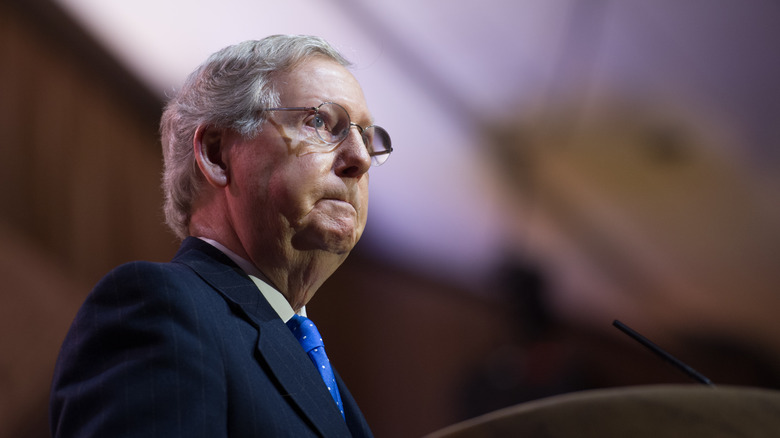 Mitch McConnell standing at podium