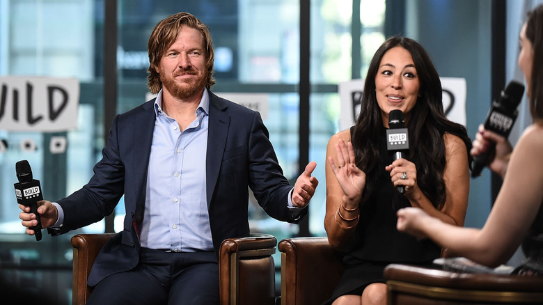 Chip and Joanna Gaines chat animatedly at one of their book launches.