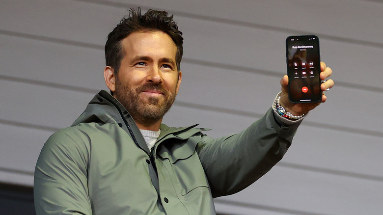 Ryan Reynolds talking to Rob McElhenney, fellow Co-Owner of Wrexham, on the phone during the Emirates FA Cup Fourth Round match