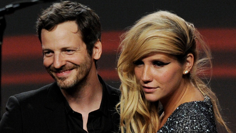 Kesha and Dr. Luke on stage, smiling