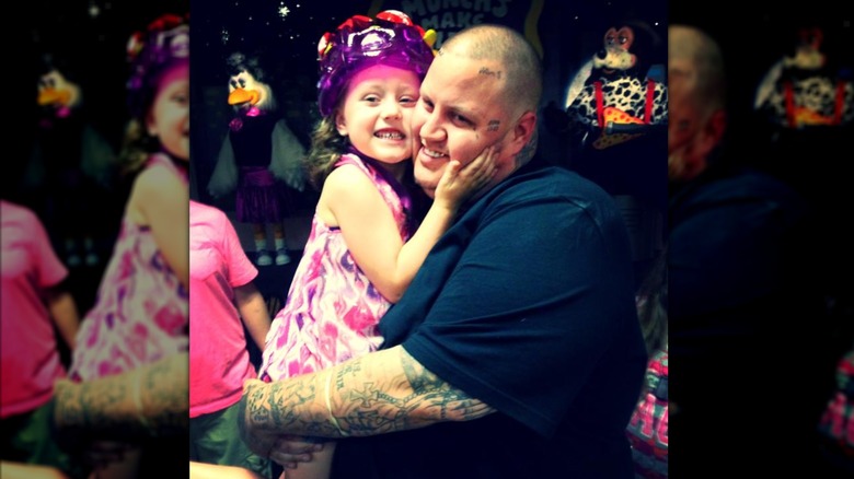 Jelly Roll holding a 5-year-old Bailee Ann