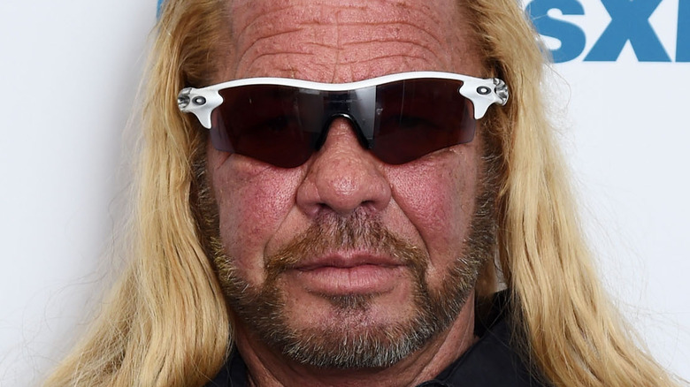 Dog the Bounty Hunter poses sunglasses