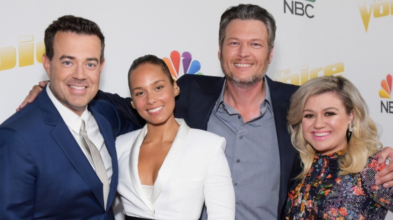 Host Carson Daly poses with judges Alicia Keys, Blake Shelton, and Kelly Clarkson at a press event