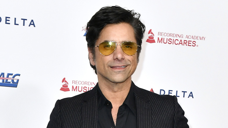 John Stamos smiling with sunglasses