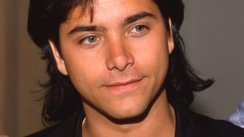 Young John Stamos posing