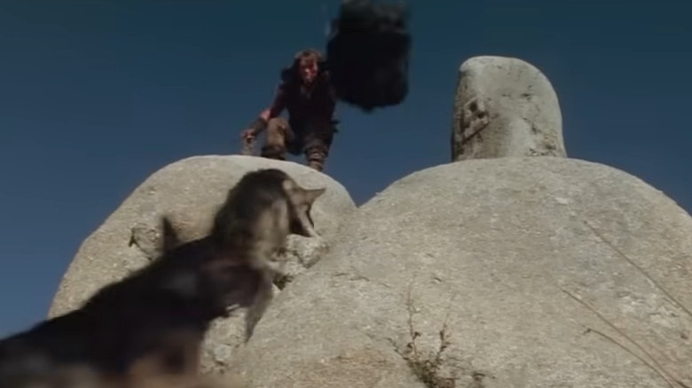Arnold Schwarzenegger as Conan running from wolves
