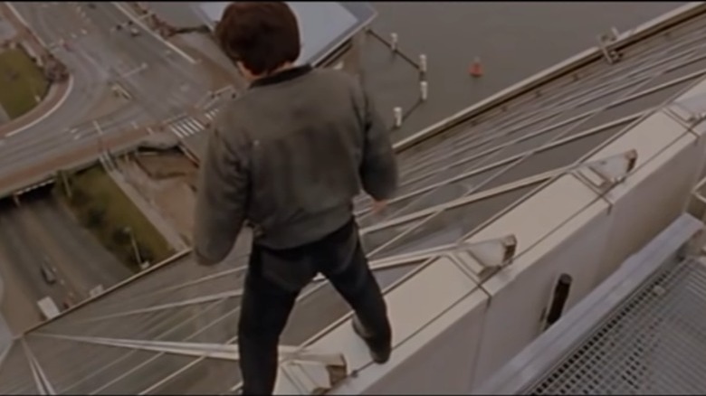 Jackie Chan about to slide down a building in Who Am I?