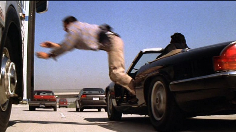 Keanu Reeves jumping from a Jaguar to a bus in Speed
