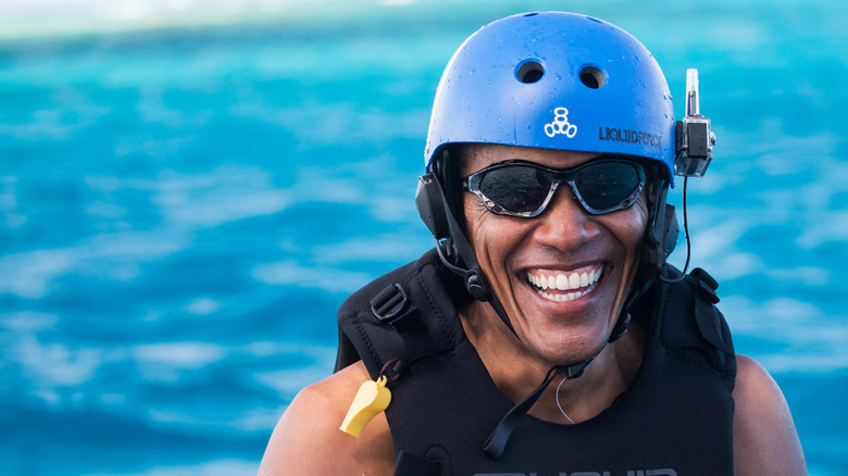 Barack Obama smiling while kitesurfing