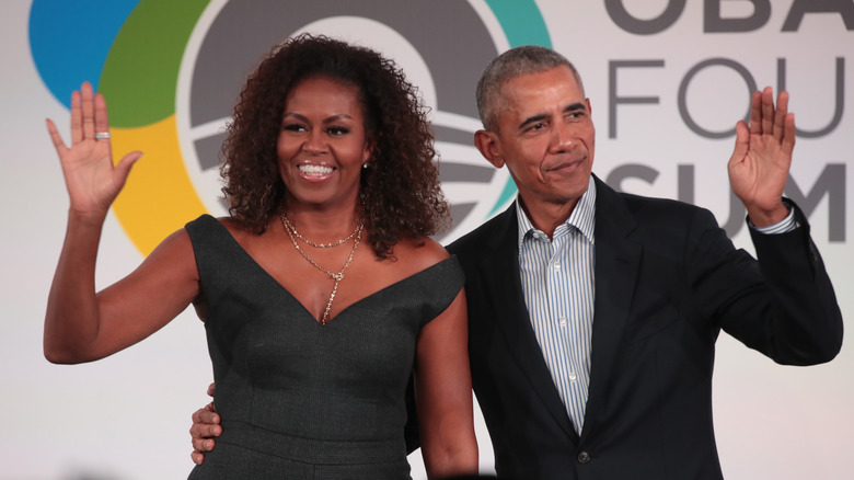 Barack and Michelle Obama both waving
