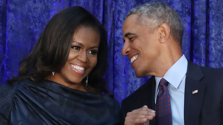 Barack and Michelle Obama smiling at an event