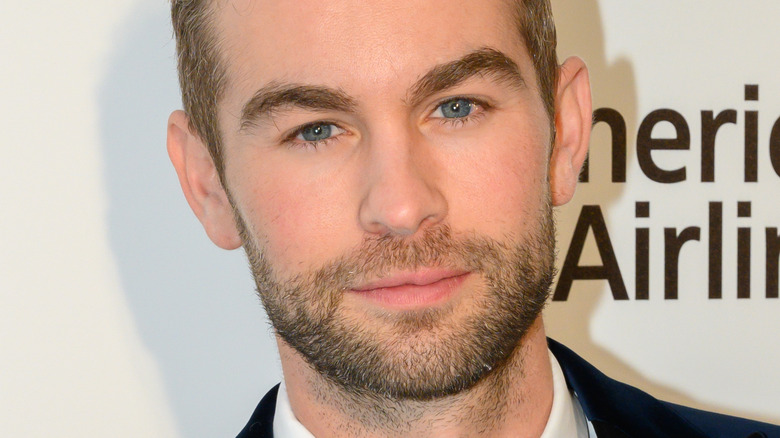 Chace Crawford wearing suit with slight smile