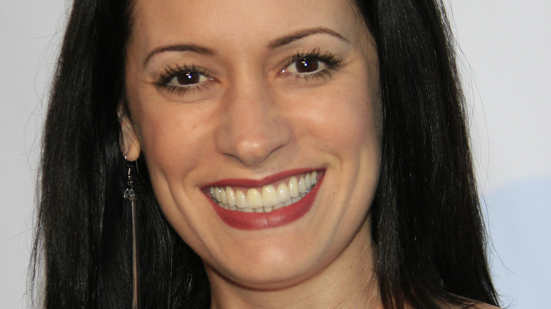 Paget Brewster looking at camera with wide smile