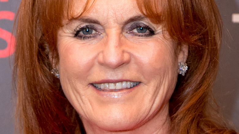 Sarah Ferguson smiles in a red dress.