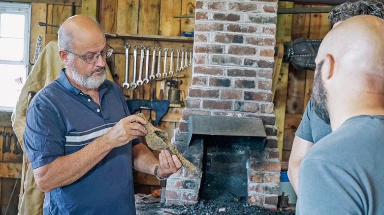 Blacksmithing expert Carmen Legge gets a closer look at what looks to be an old pick axe recently discovered on Oak Island.  
