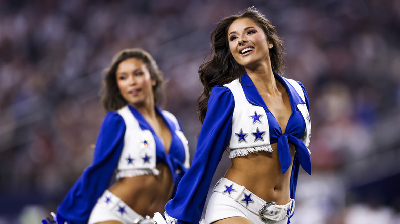 Two Dallas Cowboy Cheerleaders on the field