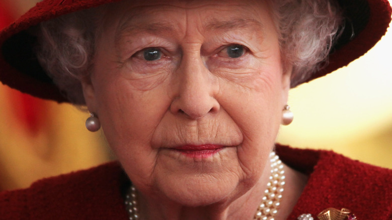Queen Elizabeth glaring in red