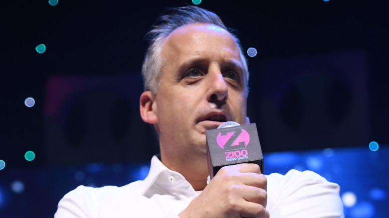 Joe Gatto onstage speaking into a microphone
