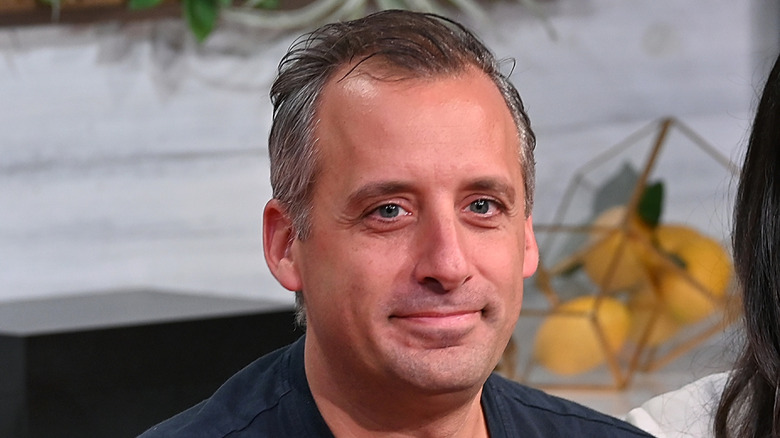 Joe Gatto seated in front of a white background