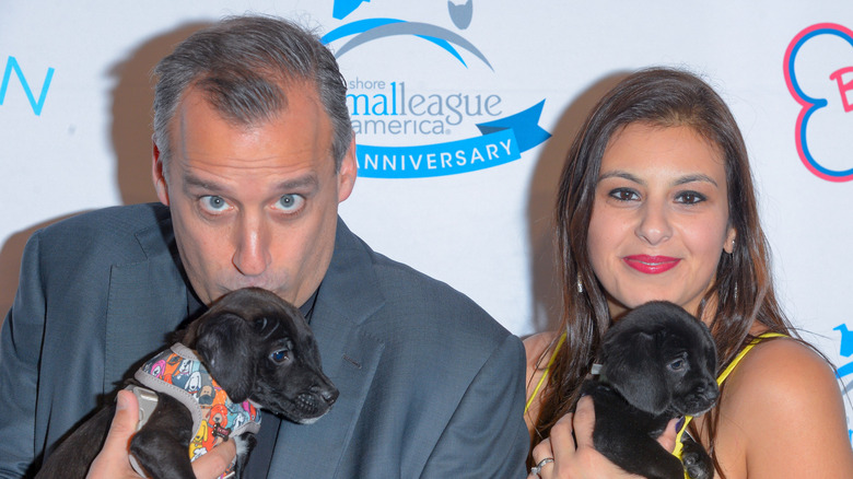Joe Gatto and wife Bessy holding small dogs