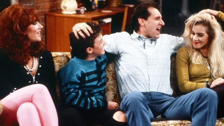 Ed O'Neill and Katey Sagal smiling on the set of Married with Children