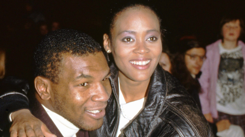 Mike Tyson being embraced by Robin Givens