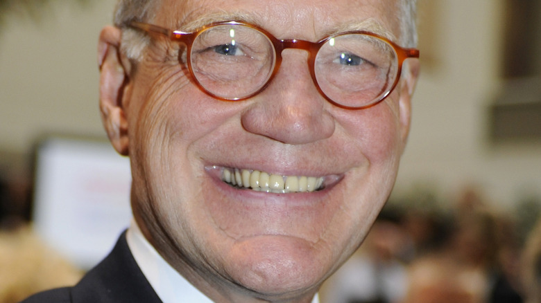 David Letterman wears brown rimmed glasses