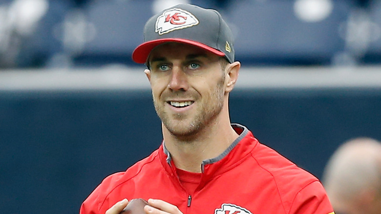 Alex Smith wearing a Chiefs cap