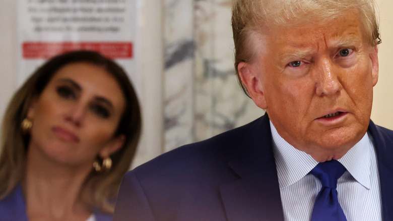 Alina Habba behind Donald Trump