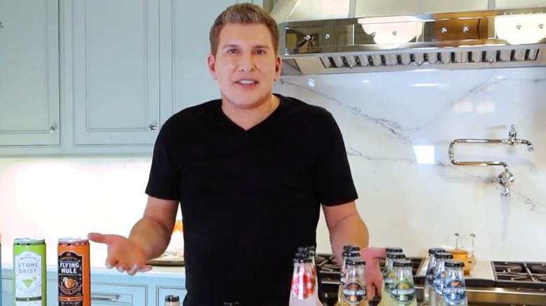 Todd Chrisley gestures with his hands while promoting a set of Beckett's drinks in the kitchen.
