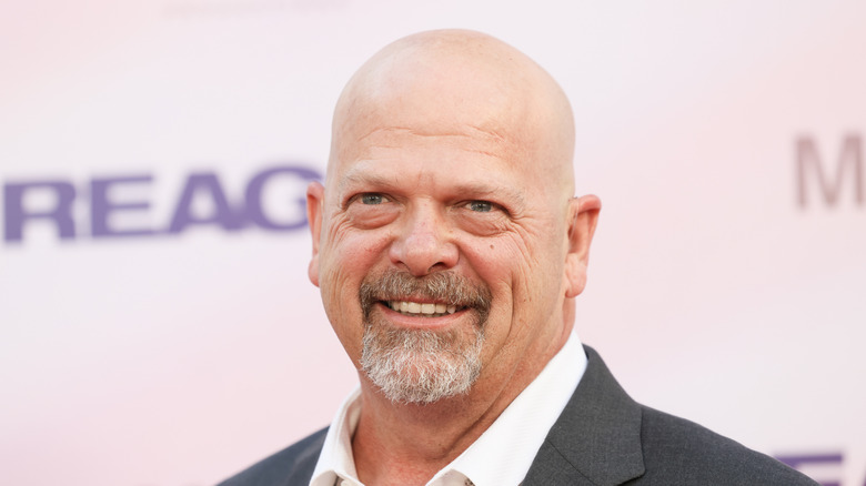 Rich Harrison smiles in gray suit in 2024