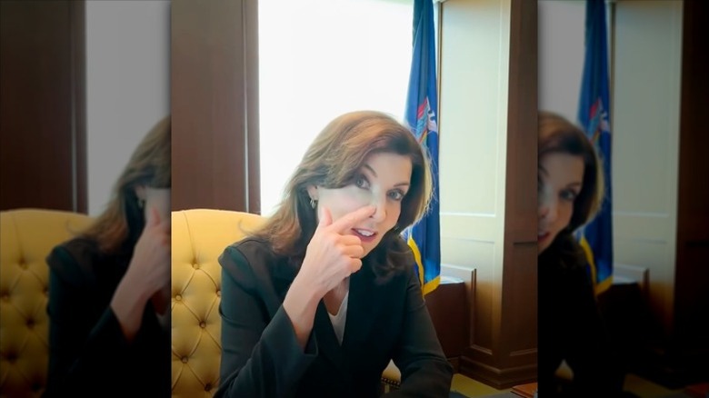 Kathy Hochul sits at her desk showing band-aid on nose