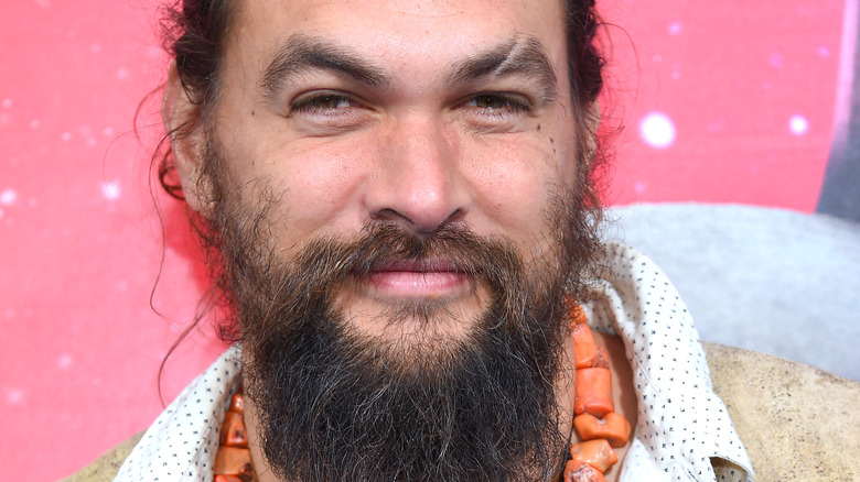 Jason Momoa with his hair pulled back