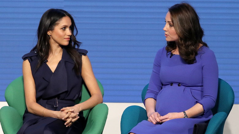 Meghan Markle and Kate Middleton talking