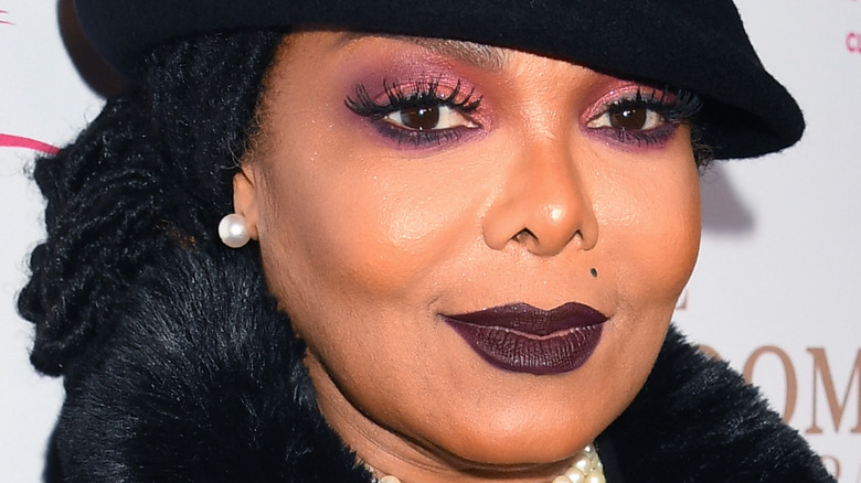 Janet Jackson wearing black hat