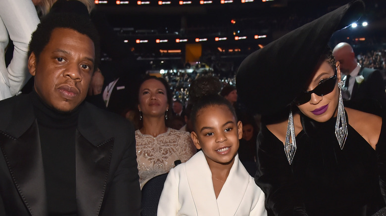 Jay Z, Blue Ivy, and Beyoncé smiling at the Grammys