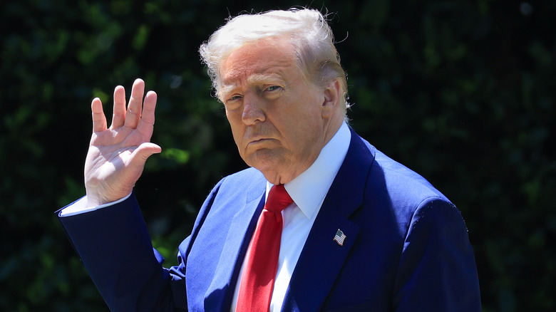 Donald Trump waves to reporters.
