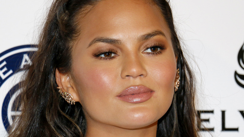 Chrissy Teigen poses on the red carpet